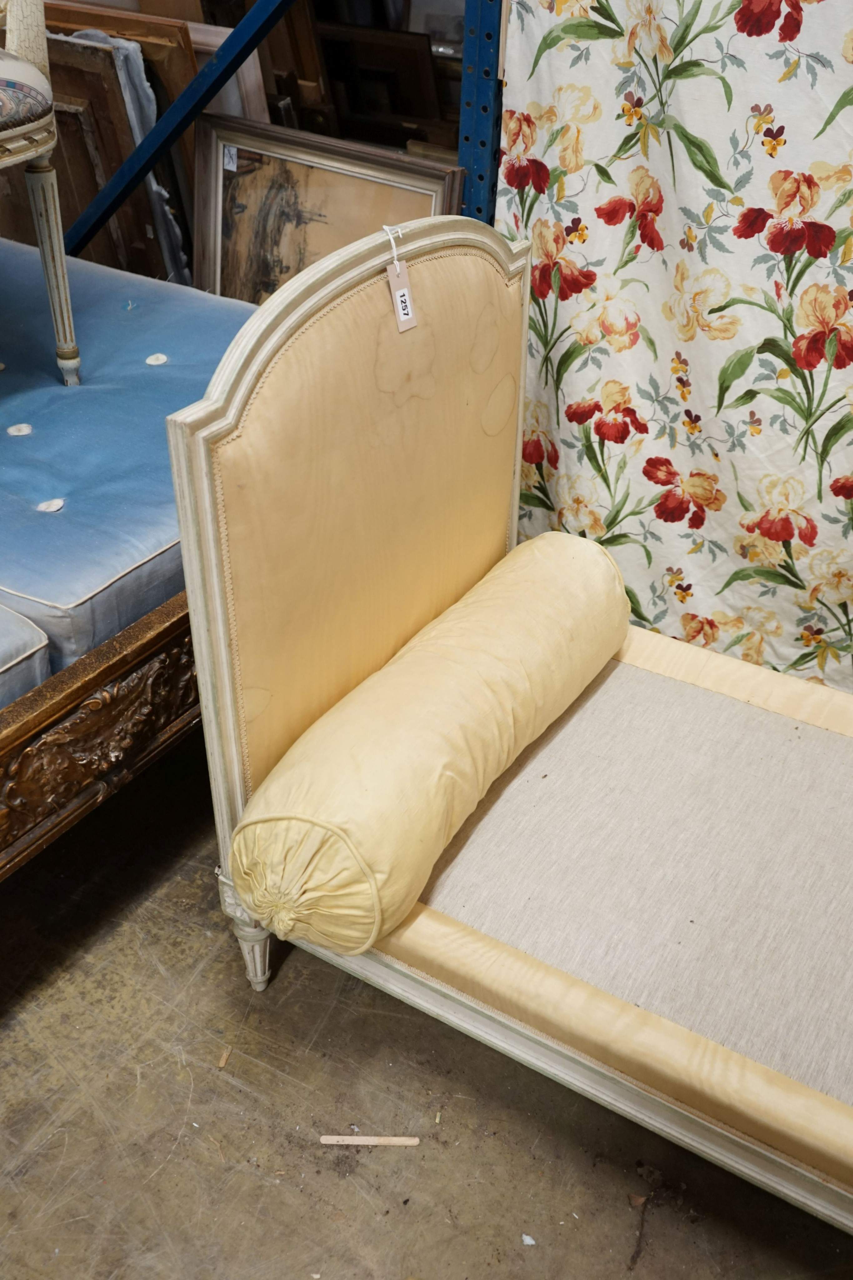 A Louis XVI style yellow painted upholstered French daybed, width 198cm, depth 69cm, height 88cm